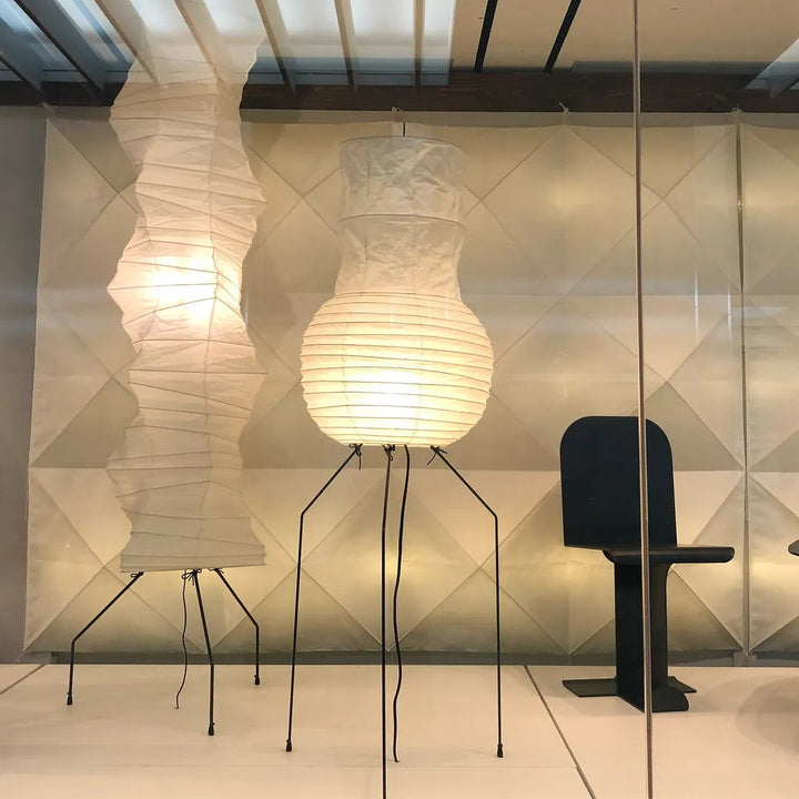 "Minimalist rice paper floor lamp with sleek metal frame and soft diffused light, perfect for creating a warm ambiance."