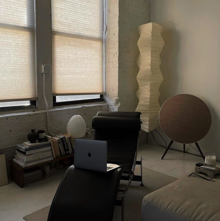 "Minimalist rice paper floor lamp with sleek metal frame and soft diffused light, perfect for creating a warm ambiance."