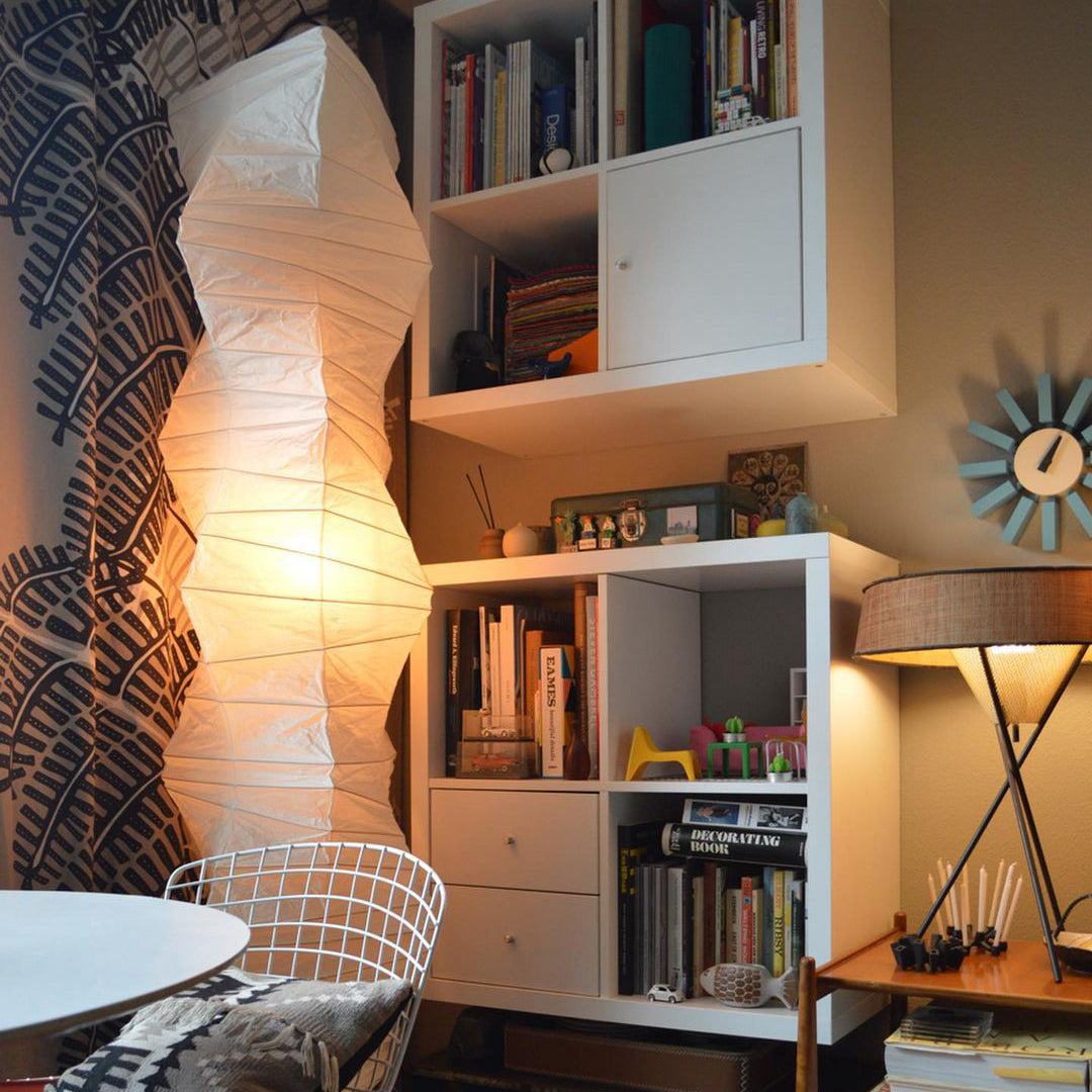 "Minimalist rice paper floor lamp with sleek metal frame and soft diffused light, perfect for creating a warm ambiance."