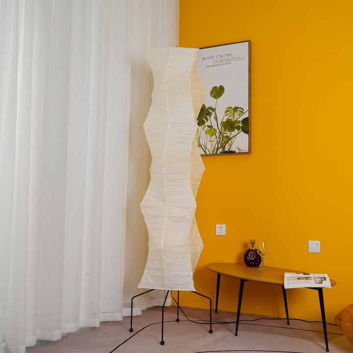 "Minimalist rice paper floor lamp with sleek metal frame and soft diffused light, perfect for creating a warm ambiance."