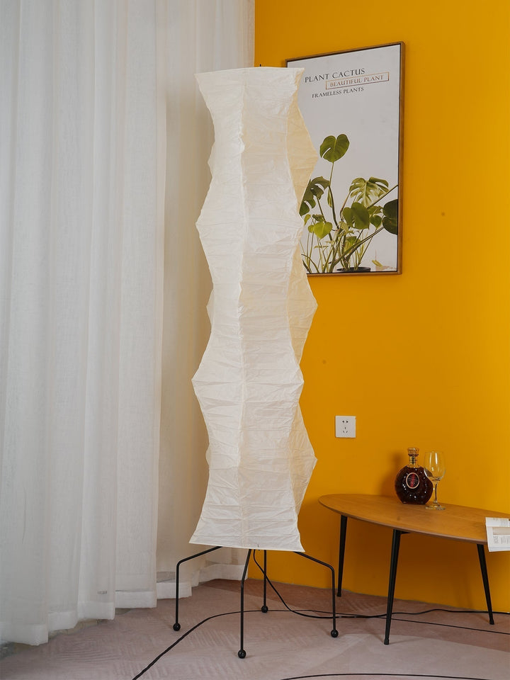 "Minimalist rice paper floor lamp with sleek metal frame and soft diffused light, perfect for creating a warm ambiance."