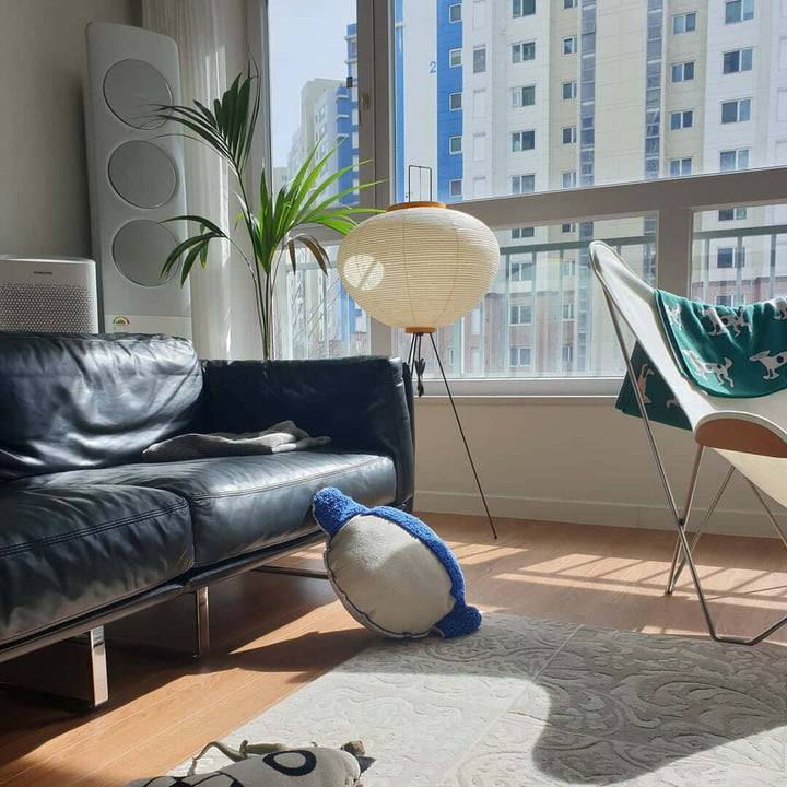 "Minimalist rice paper floor lamp with sleek metal frame and soft diffused light, perfect for creating a warm ambiance."