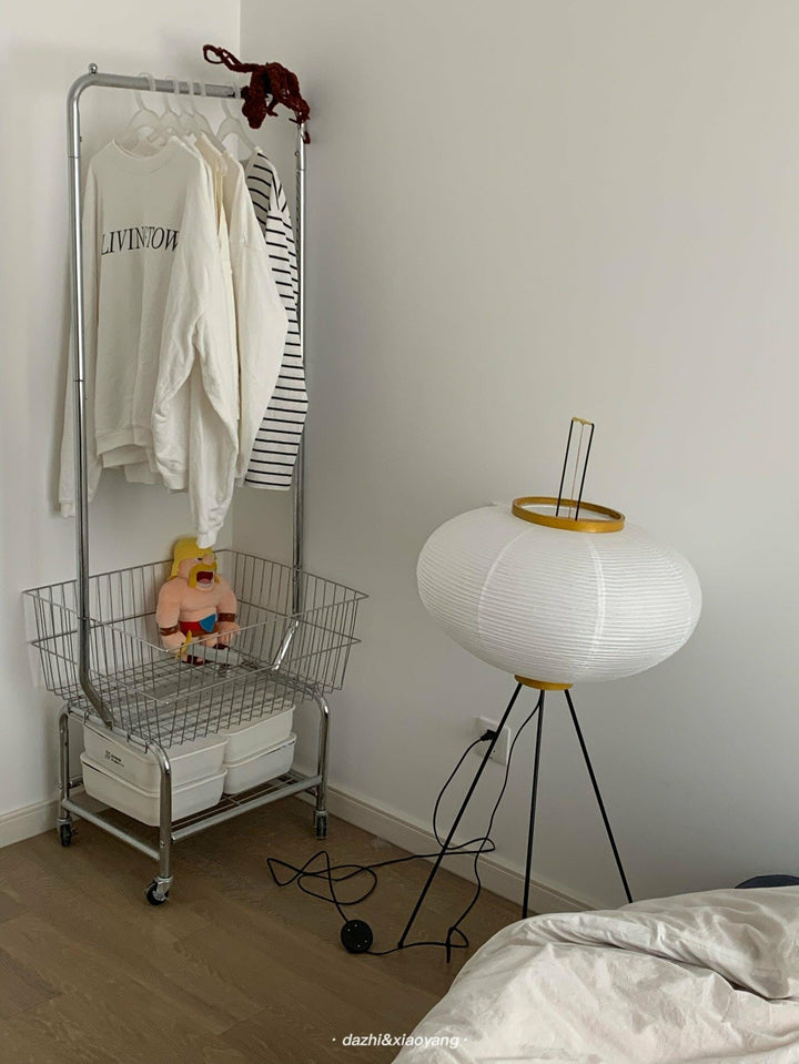 "Minimalist rice paper floor lamp with sleek metal frame and soft diffused light, perfect for creating a warm ambiance."