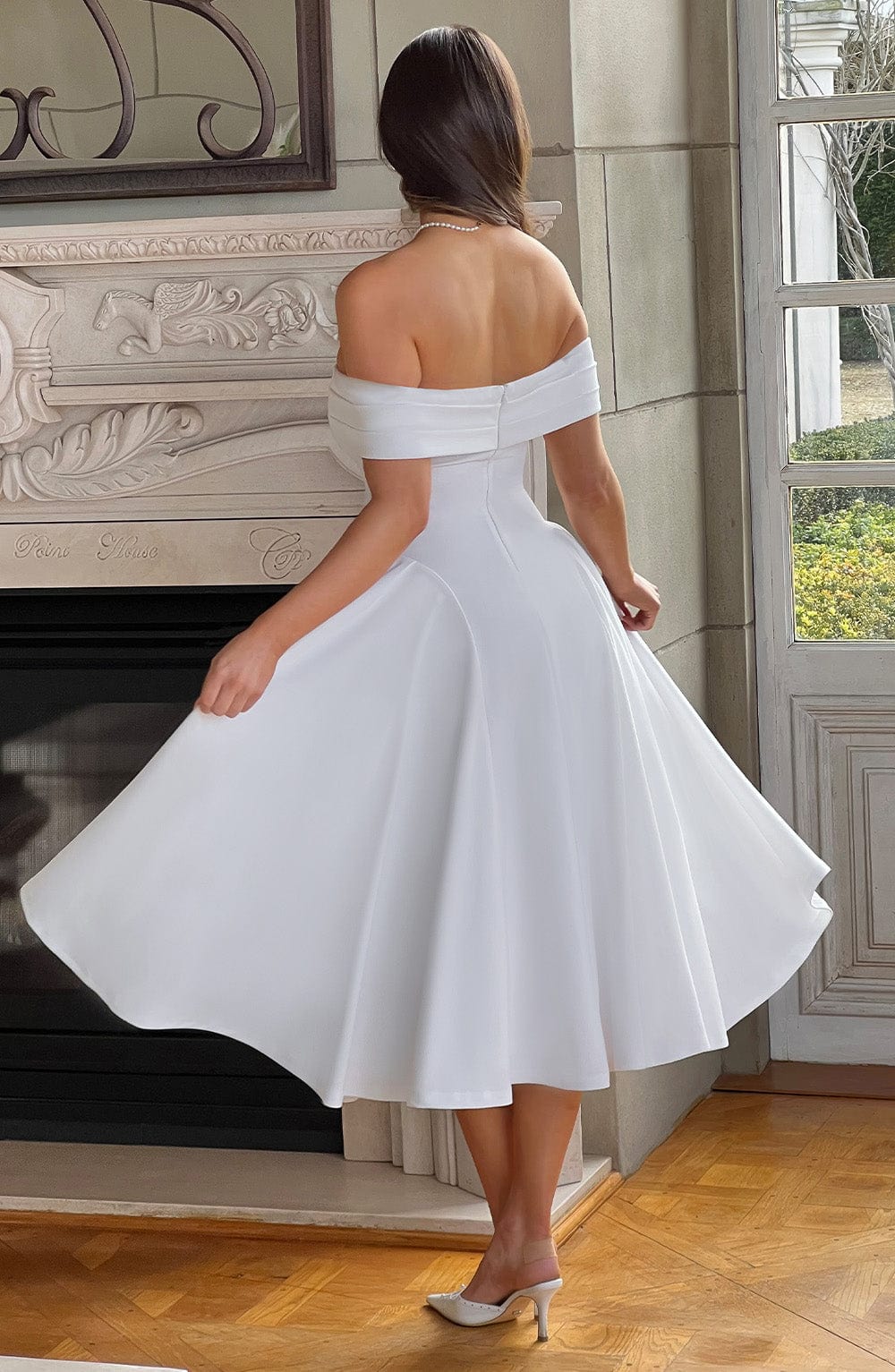 White elegant off-shoulder pleated midi dress, ideal for women attending a special occasion or as a party dress.