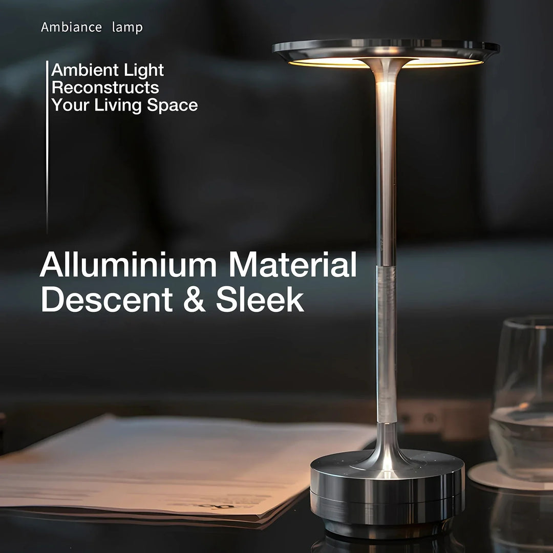 Modern cordless table lamp with touch control, Nordic design, gold frame, brushed finish, illuminating a stylish room.
