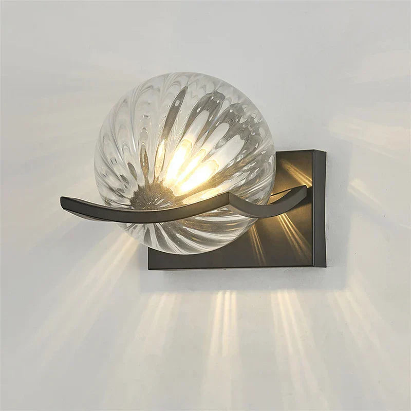 Modern LED wall lamp with sleek glass finish, ideal for contemporary home decor and energy-efficient lighting.