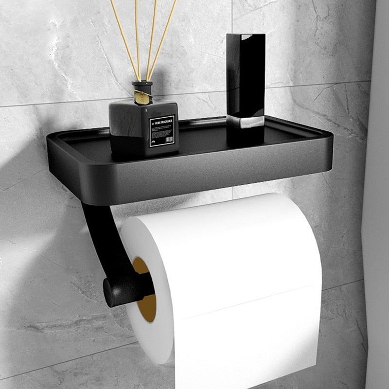 Modern stainless steel toilet roll holder with a convenient storage shelf, ideal for bathroom organization.