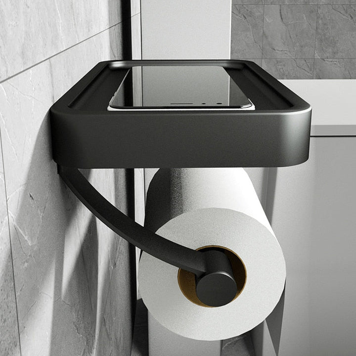 Sleek stainless steel toilet roll holder with a practical storage shelf for phone or small bathroom items.