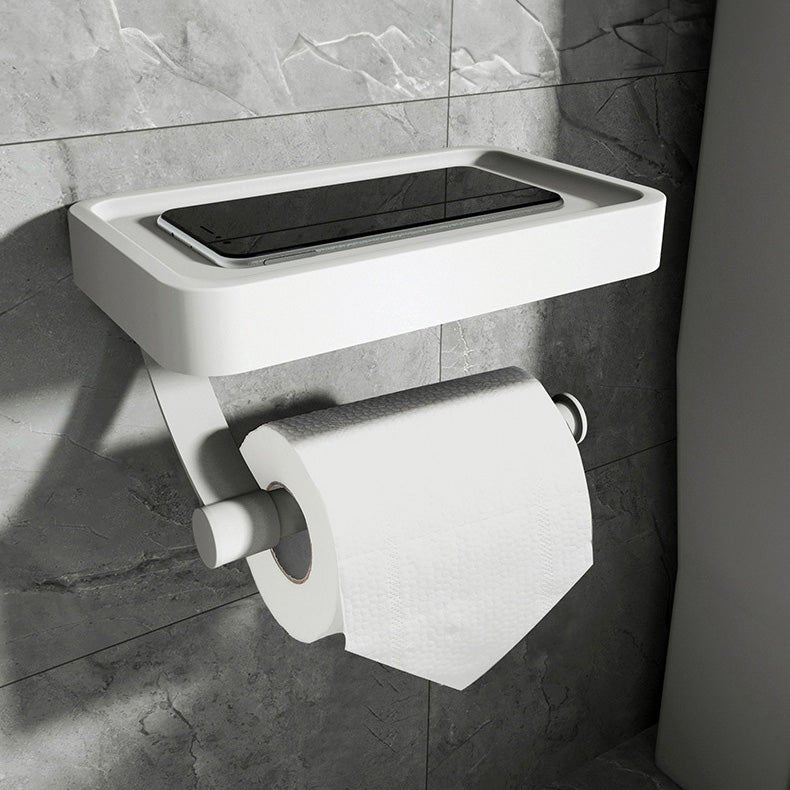 Space-saving stainless steel toilet roll holder with integrated storage shelf, perfect for modern bathroom decor.