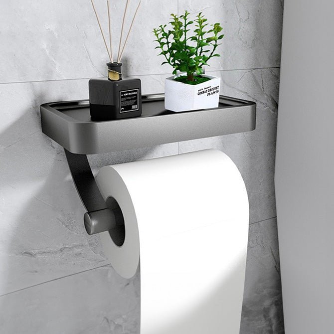 Stylish no-drill stainless steel toilet paper holder with a shelf for storage, enhancing bathroom organization.