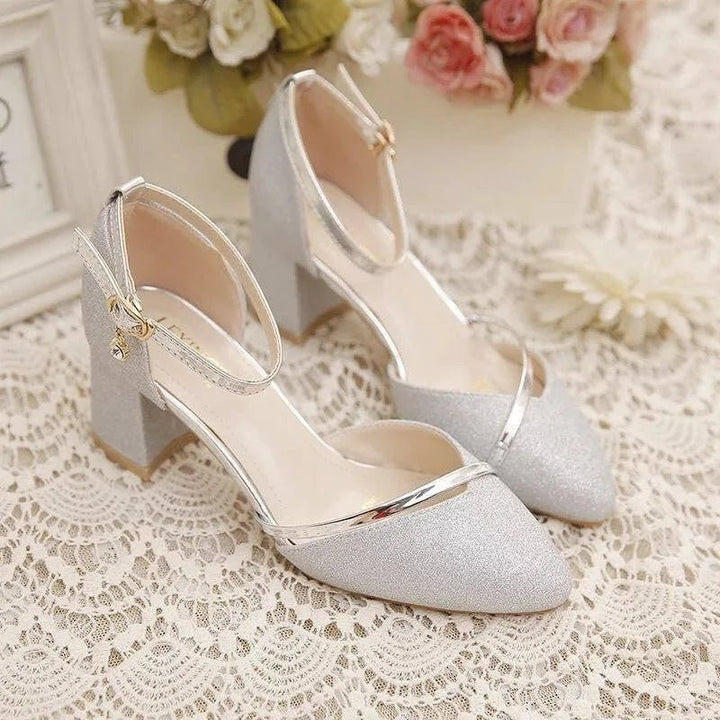 Comfortable silver block heel shoes for women, featuring an elegant ankle strap. Ideal for formal & party occasions.