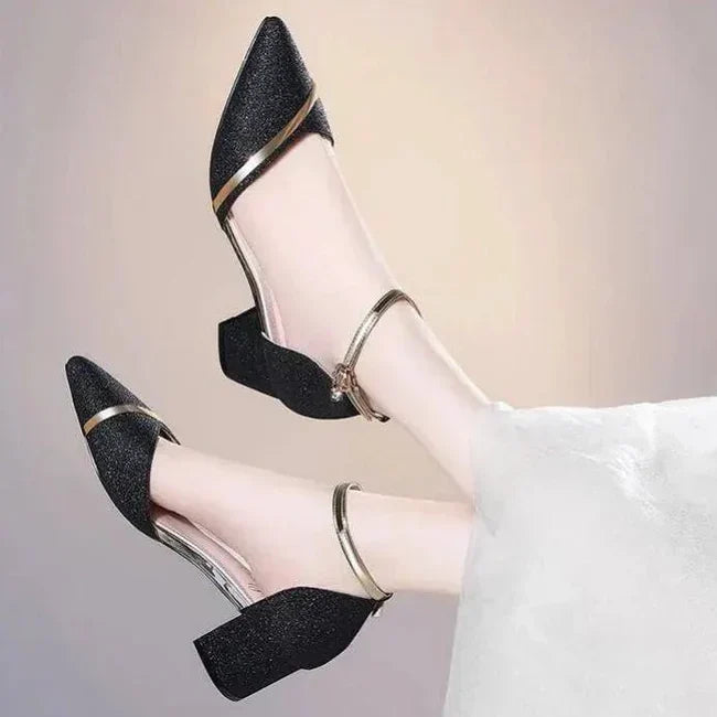 Stylish women's black block heel shoes with secure ankle strap, offering versatile comfort for events & formal wear.