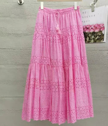 Women's flowy tiered maxi skirt in pink, white, or black. Boho style with elastic waist, perfect for summer vacation.