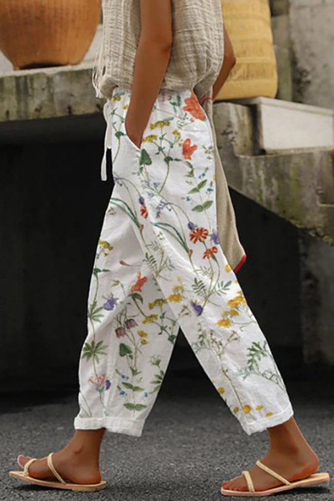 Close-up of button and pocket details on trendy women's casual printed pants. Quality fashion bottoms.