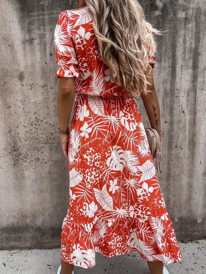 Stylish women's elegant floral print midi dress, perfect summer resort wear, paired with accessories.