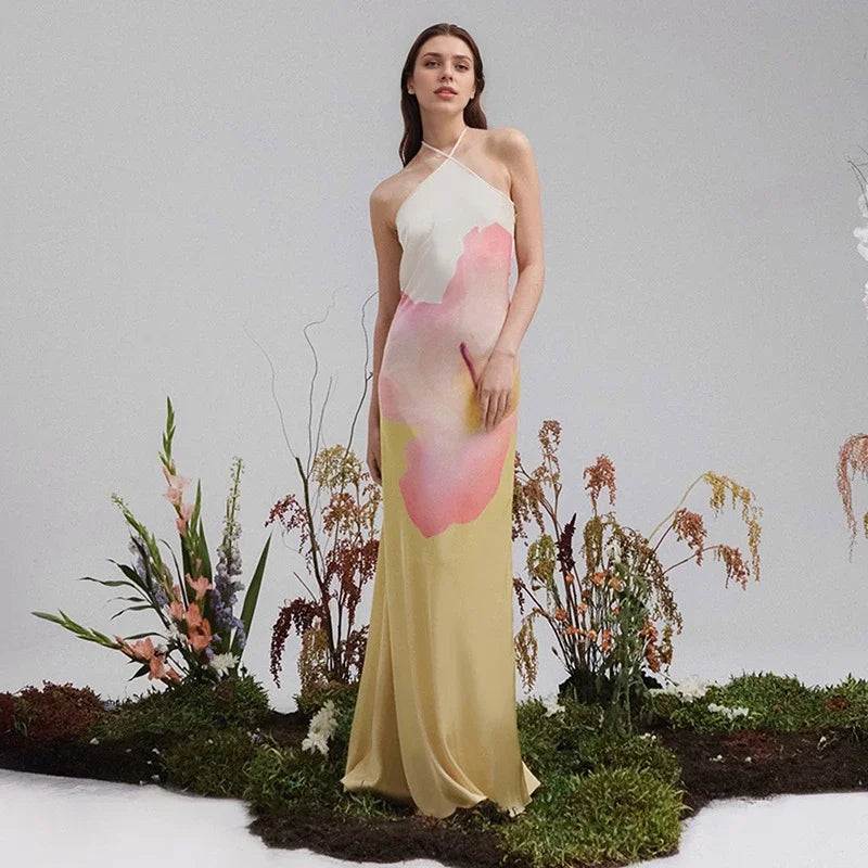 Elegant white one-shoulder maxi dress with a vibrant floral print. Ideal for women's summer parties & special events.