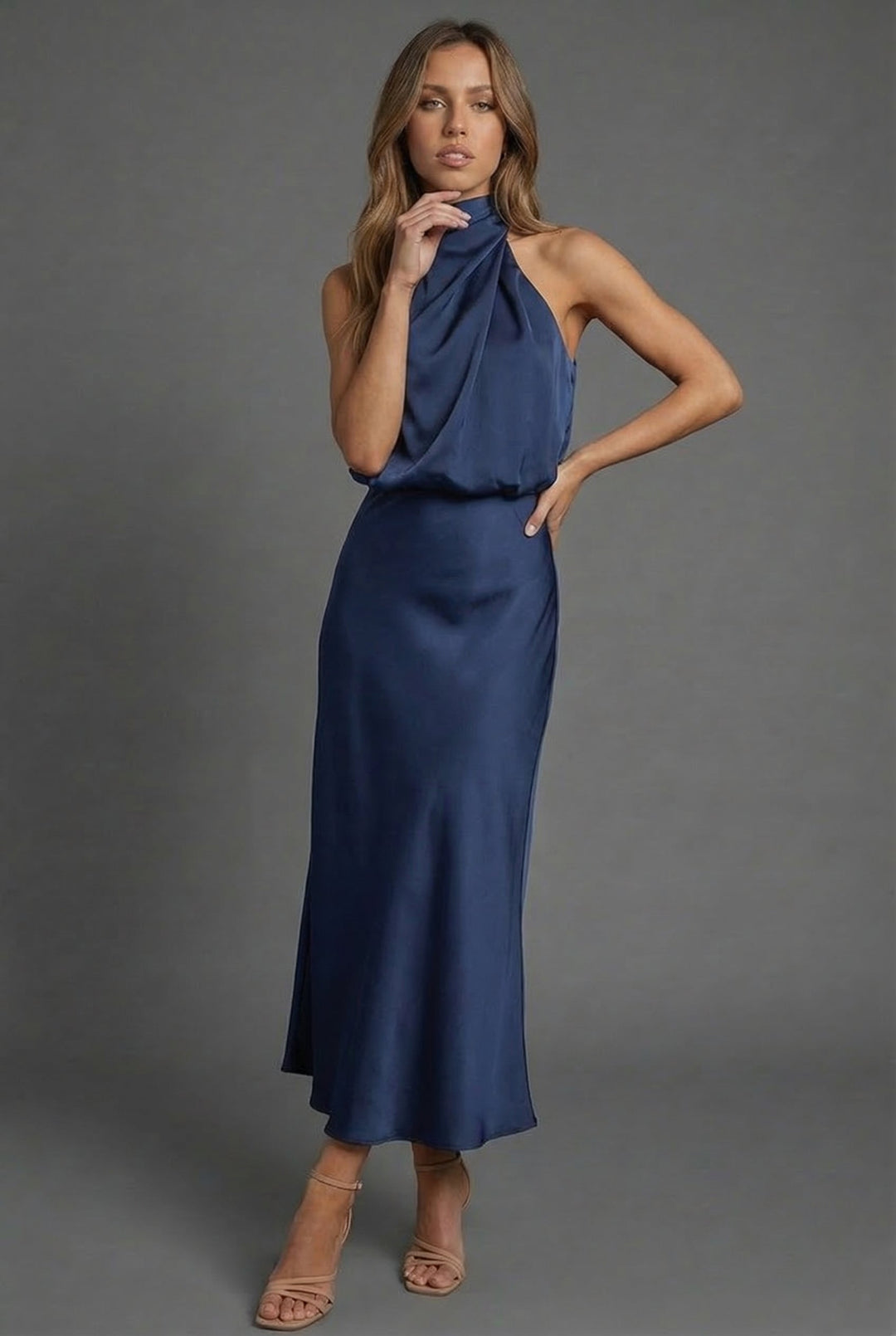 Sophisticated open-back halter midi dress, perfect for a wedding or summer event.