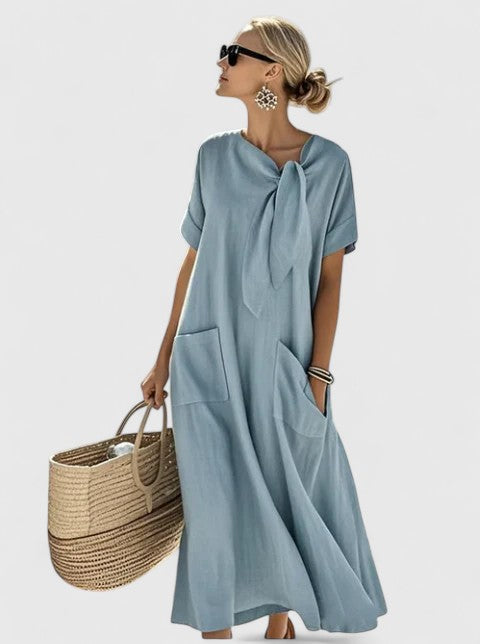 Chic women's summer midi dress with tie neck & pockets, ideal for elegant everyday wear or casual occasions.