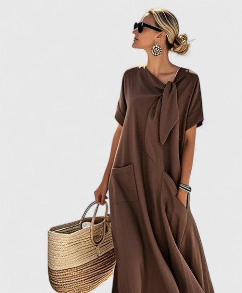 Elegant women's summer midi dress with a stylish tie neck and practical pockets, perfect for casual chic.