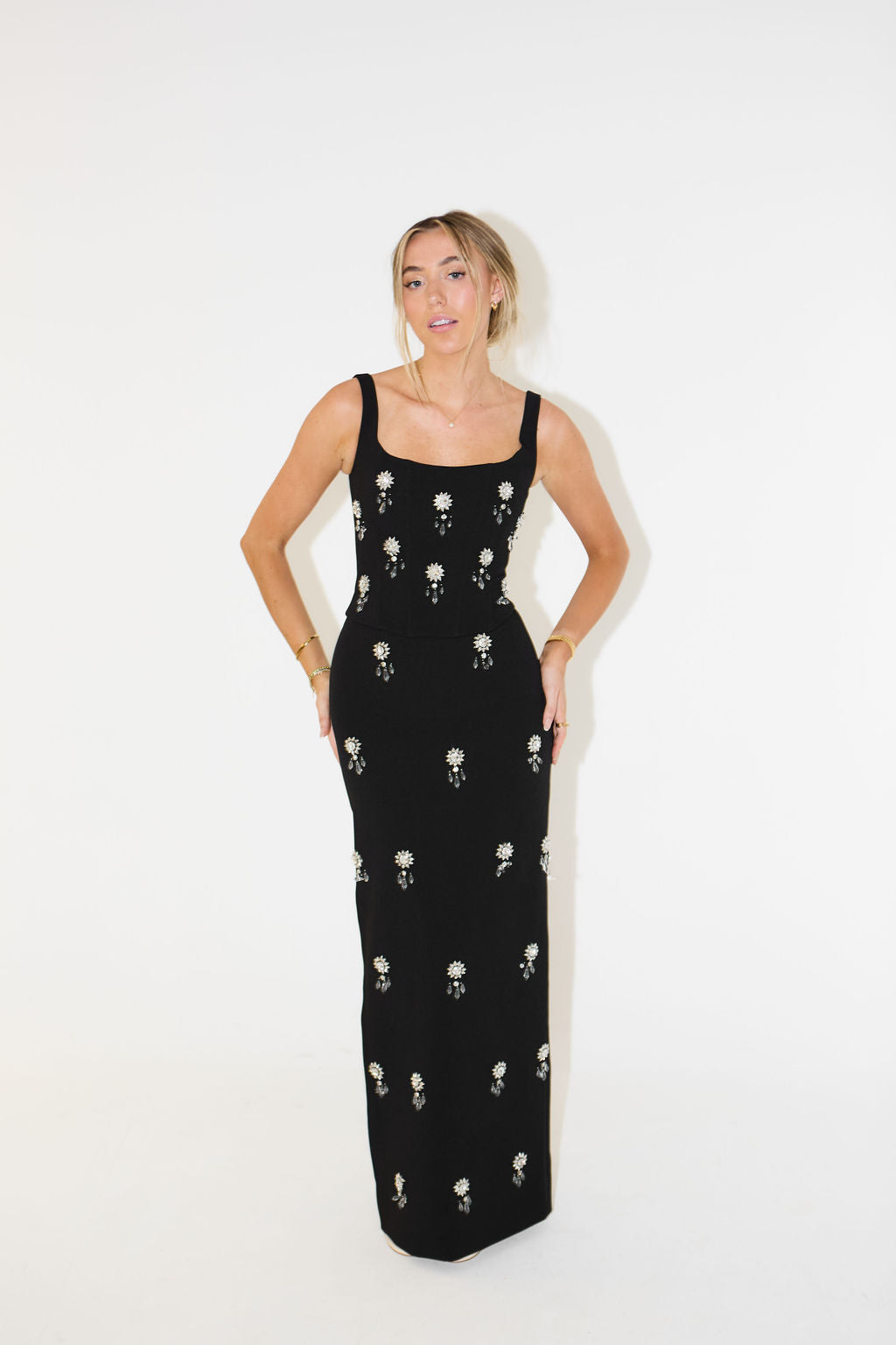 Stylish women's long skirt and top set featuring intricate crystal detailing, a chic choice for any party.