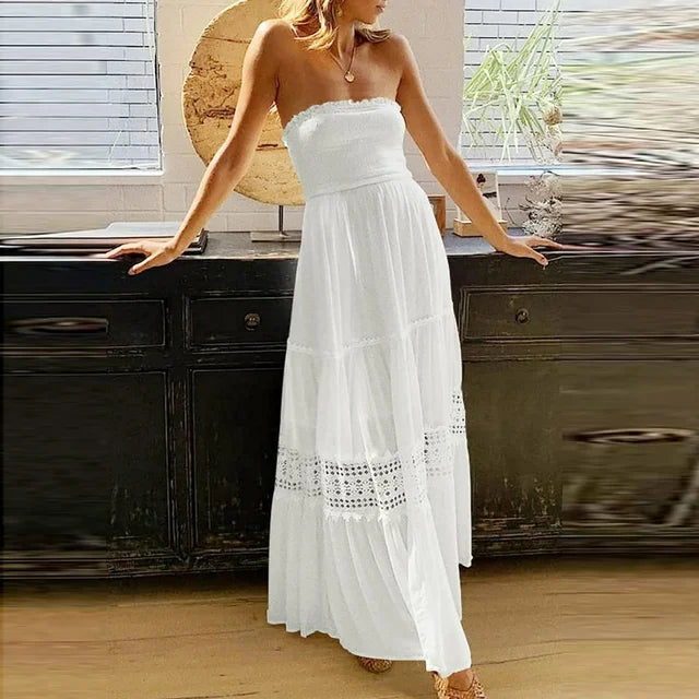 Chic women's strapless smocked high-low maxi dress with a tiered, flowy skirt, ideal for warm weather fashion.