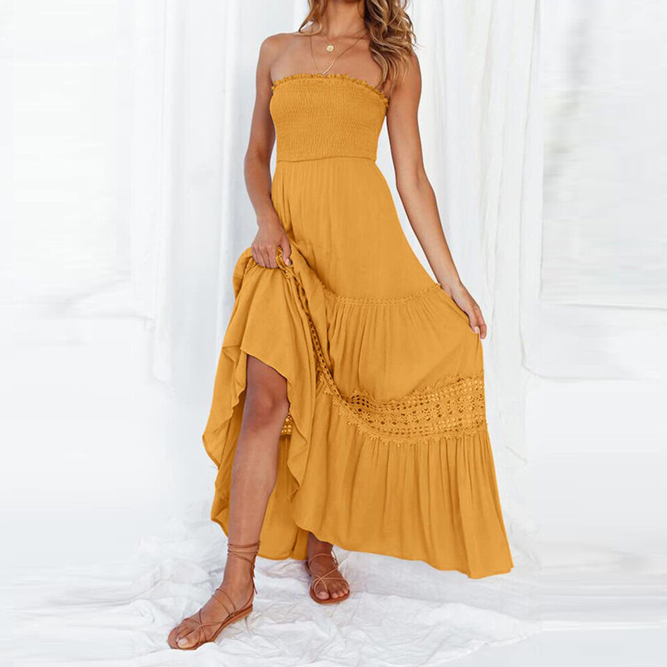 Flowy women's strapless high-low maxi dress featuring delicate lace details & a tiered skirt, ideal for summer.