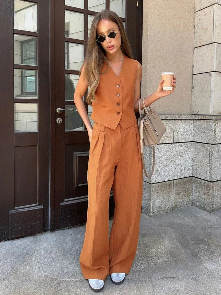 Chic women's co-ord set featuring a sleeveless vest top and smart wide-leg trousers. Ideal for smart casual summer outfits.