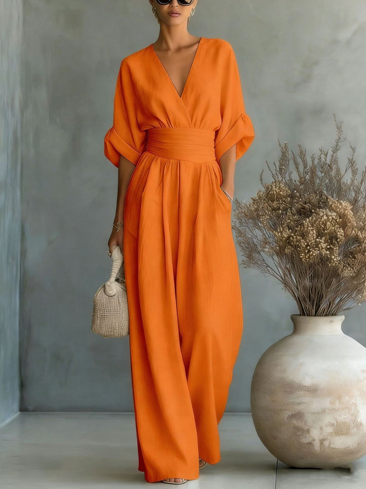 Fashionable women's deep V-neck jumpsuit featuring a chic wide-leg design for elegant party wear.