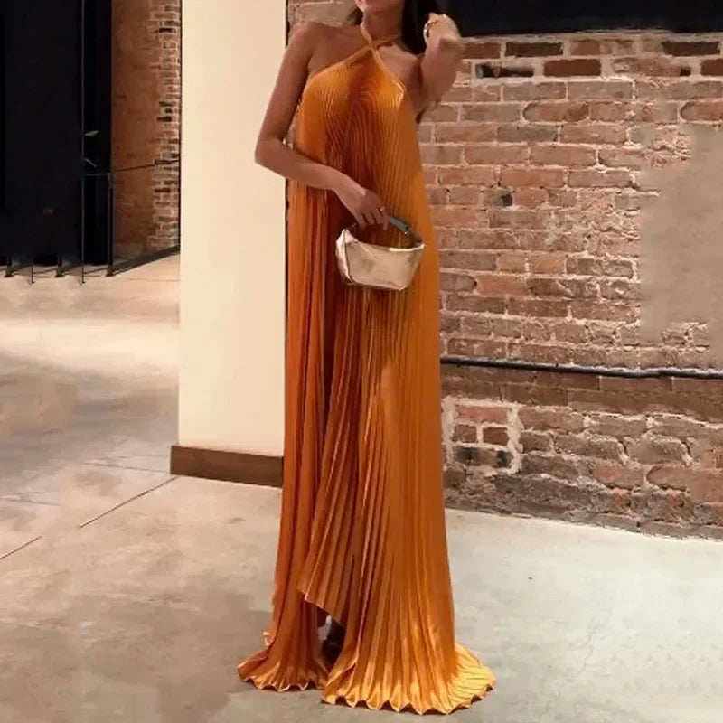 Sleeveless orange pleated maxi dress for women. Elegant neckholder style, perfect for evening events & special occasions.