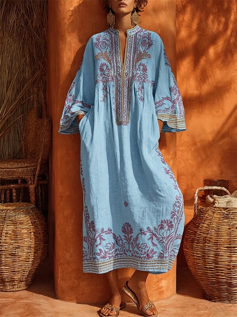 Floral embroidered V-neck maxi dress for women, featuring bell sleeves and empire waist for casual elegance.