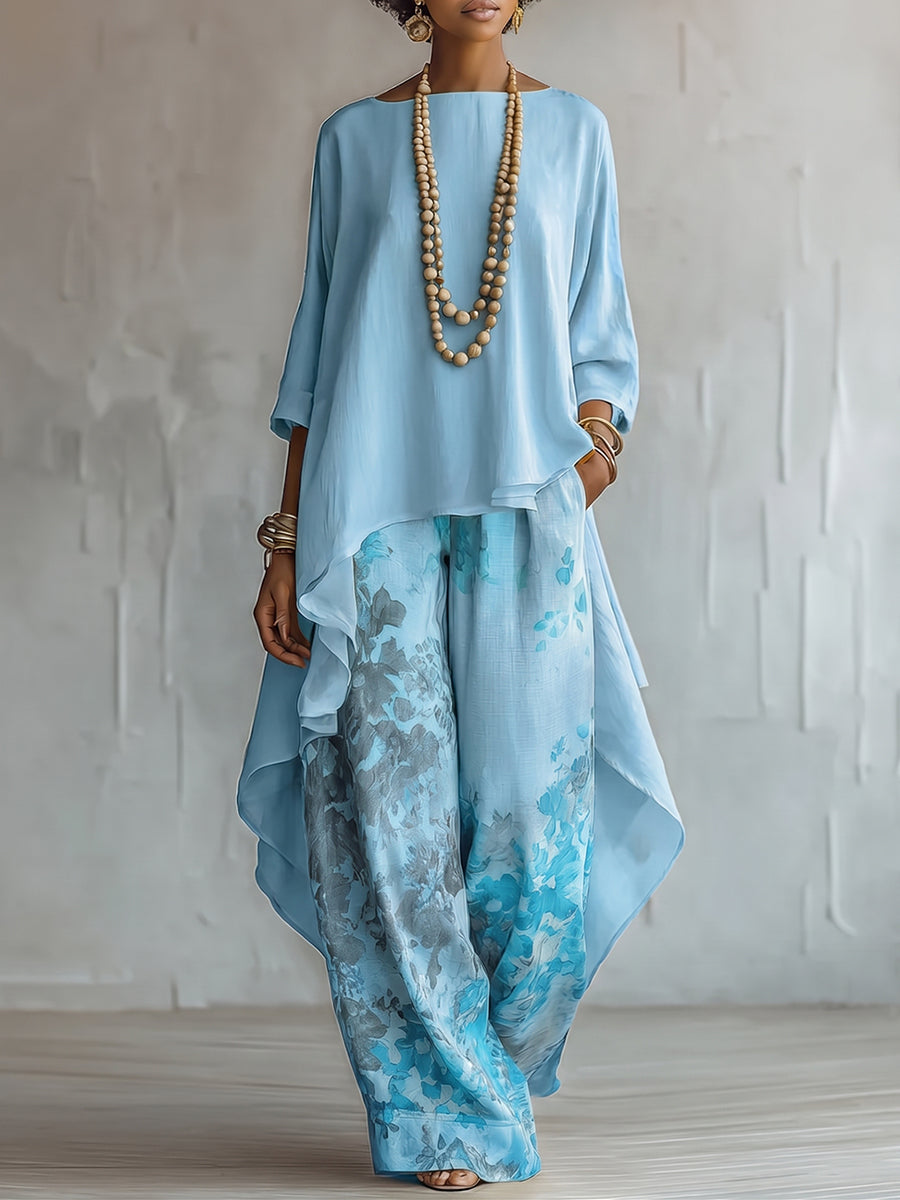Elegant women's floral two-piece set with cape top & wide leg pants. Perfect for resort wear or summer events.
