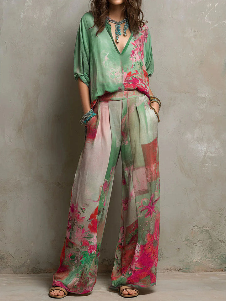 Summer women's floral two-piece outfit with wide-leg pants and a flattering V-neck top. Ideal for elegant resort wear.