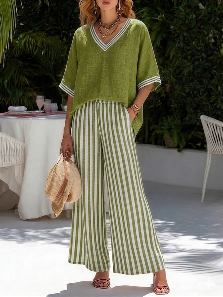 Stylish women's V-neck top and striped wide-leg pant set, a comfortable spring/summer two-piece casual outfit.