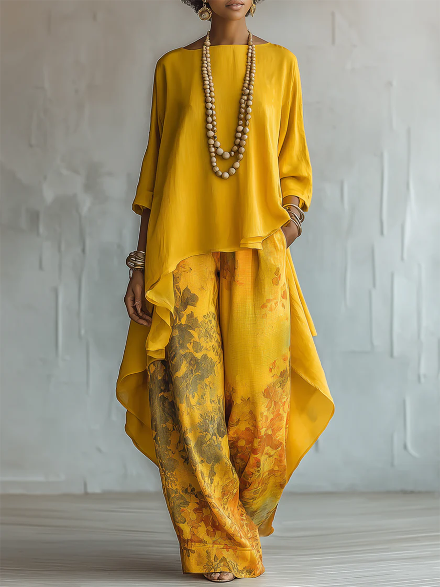 Stylish women's floral print two-piece summer outfit. Features a comfortable cape top and chic wide-leg pants.