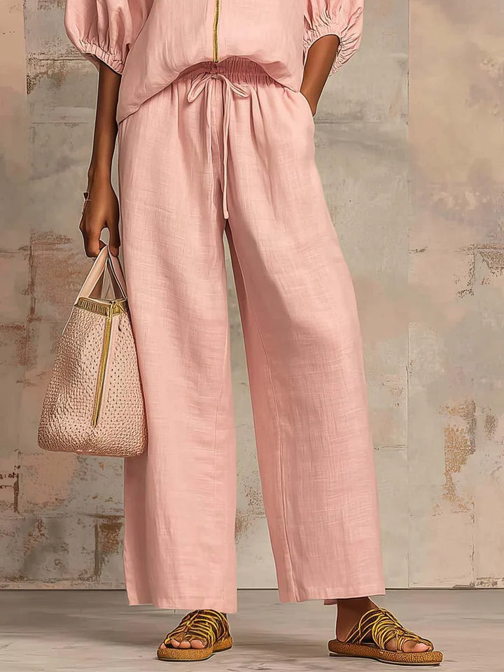 Modern women's two-piece set: a relaxed button-up shirt and comfortable wide-leg trousers for versatile everyday style.