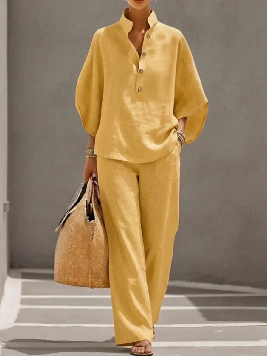 Close-up of women's linen two-piece set fabric. Breathable batwing top & wide leg trousers texture.