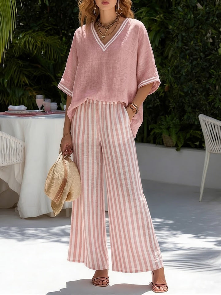 Close-up of women's comfortable V-neck top, part of a stylish two-piece set with striped wide-leg pants.