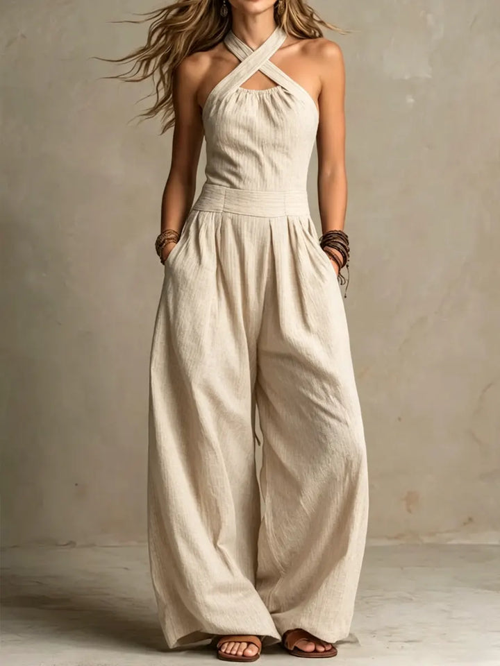 Chic women's wide-leg jumpsuit featuring a fashionable cross neckline, ideal for a comfortable and elegant summer outfit.