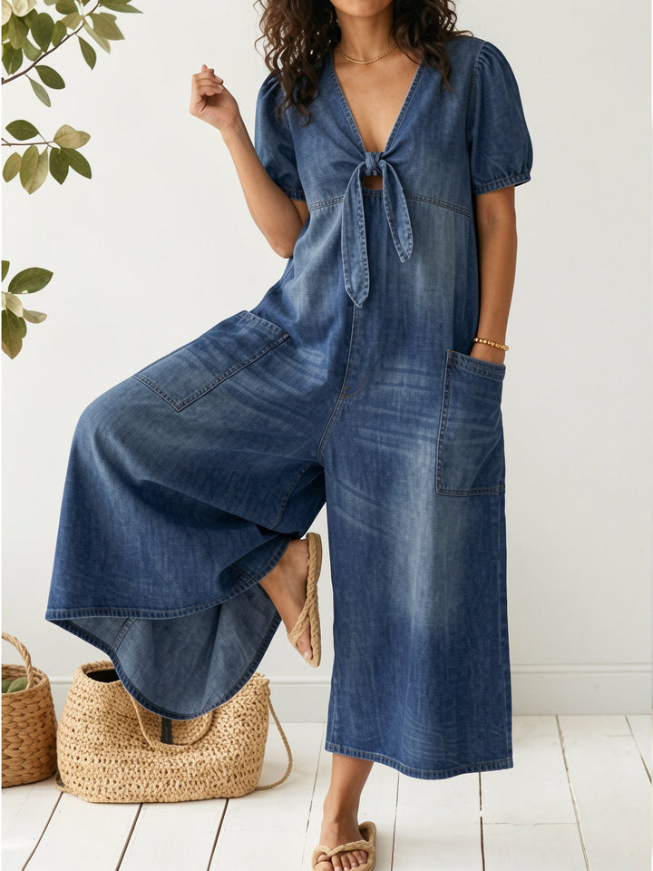 Women's effortless dark blue denim jumpsuit, relaxed fit, sleeveless, perfect for casual summer wear.