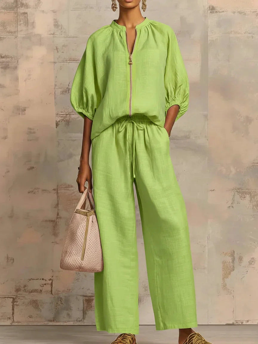 Elegant women's set for spring/summer: relaxed button-up shirt & chic wide-leg trousers. Versatile two-piece outfit.