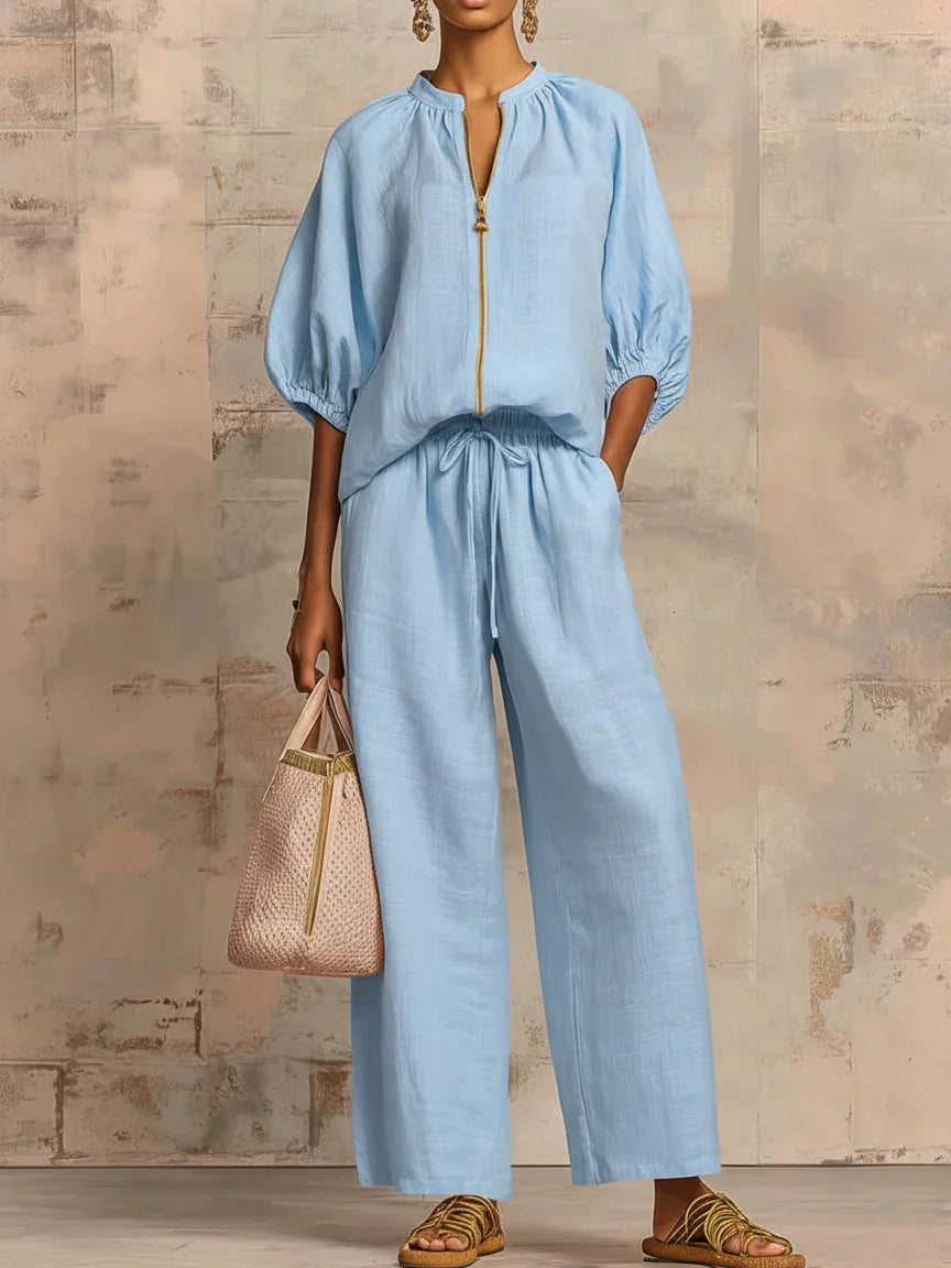 Stylish women's two-piece outfit: a relaxed button-up shirt and flowing wide-leg trousers. Elegant & versatile set.