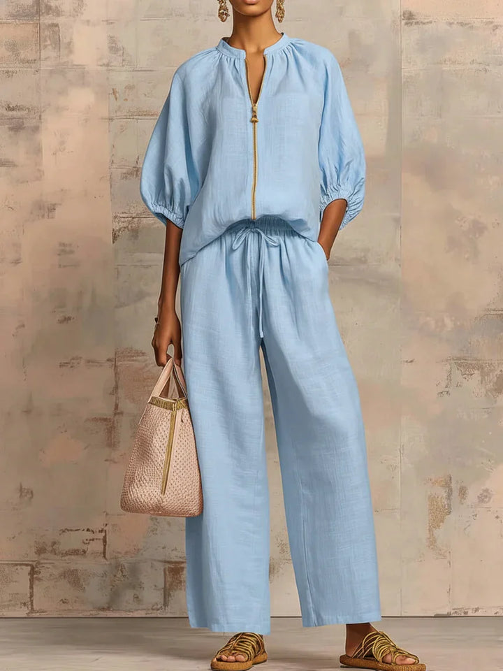 Stylish women's two-piece outfit: a relaxed button-up shirt and flowing wide-leg trousers. Elegant & versatile set.