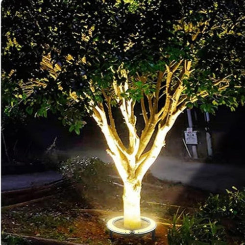 "Outdoor LED spotlights softly lighting tree bases with warm white glow, enhancing garden aesthetics with elegant aluminum de