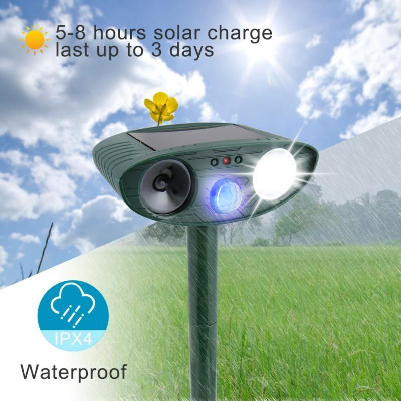 "Outdoor solar-powered ultrasonic deer repeller in garden setting, showcasing green and grey weather-resistant design."