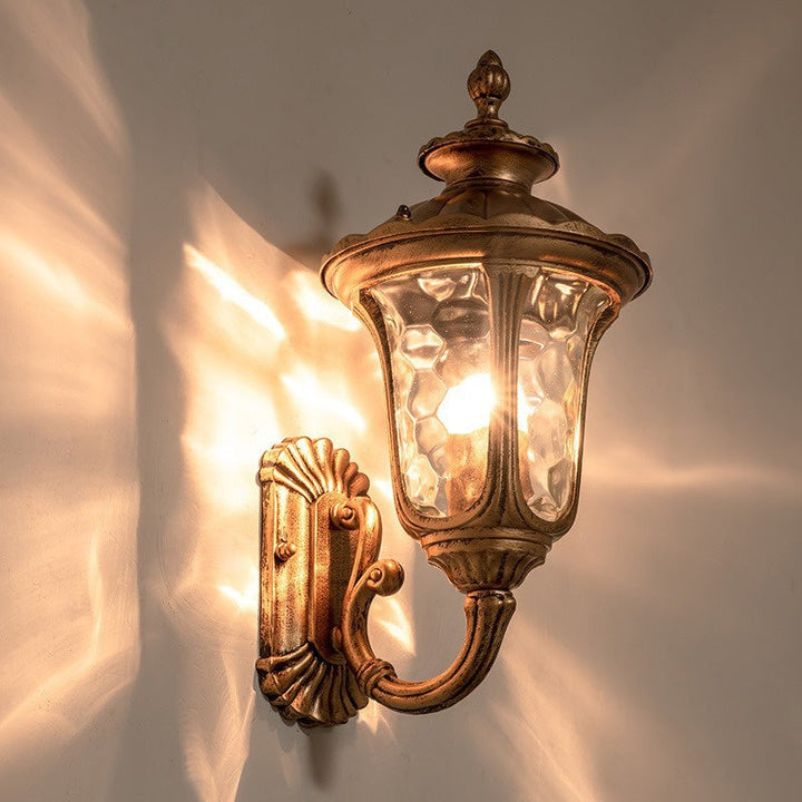 "Outdoor waterproof bronze wall light with clear water glass shade, elegant design for stylish exterior lighting."