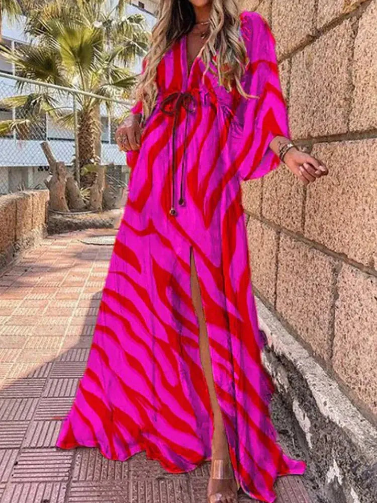 Elegant flowing abstract print maxi dress for women, featuring a deep V-neck and tie waist. Ideal for beach or holiday.