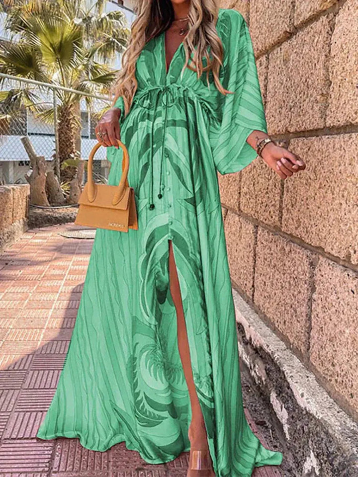 Women's elegant deep V-neck abstract print maxi dress. Flowing bohemian style, ideal for summer, beach, or holiday wear.