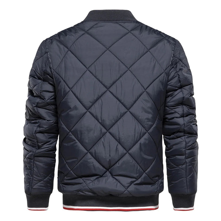 Man wearing a stylish black diamond quilted bomber jacket, ideal men's outerwear for a modern, casual look.