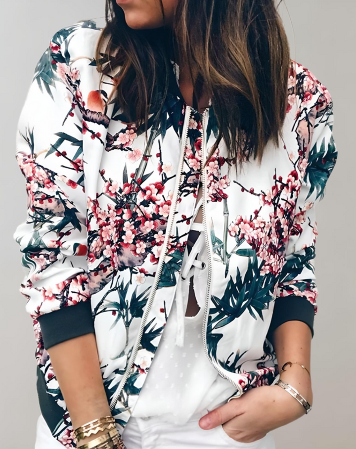 Women's vibrant floral bomber jacket with chic print. Stylish, lightweight spring outerwear for a fashionable look.