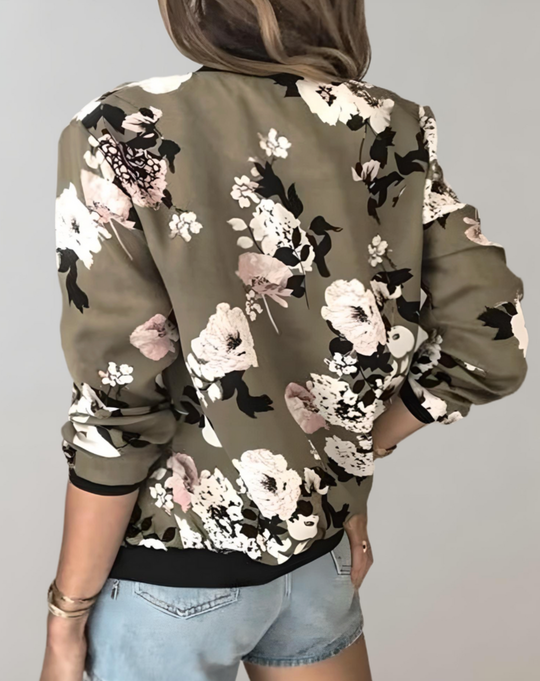 Chic women's floral bomber jacket with vibrant print. Fashionable, lightweight spring outerwear for a stylish and elegant look.